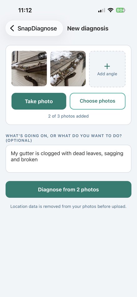 The SnapDiagnose capture screen with two photos of a clogged gutter added and room for a third.